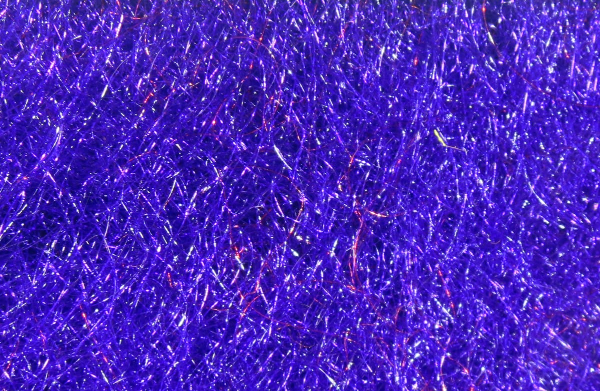 Vibrant violet synthetic trilobal dubbing with metallic sparkle, fine fibrous strands for fly tying