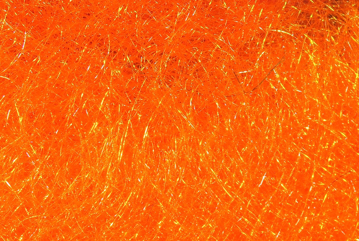Hareline STS trilobal fly tying dubbing in bright fluorescent orange with fine iridescent gold synthetic fibers