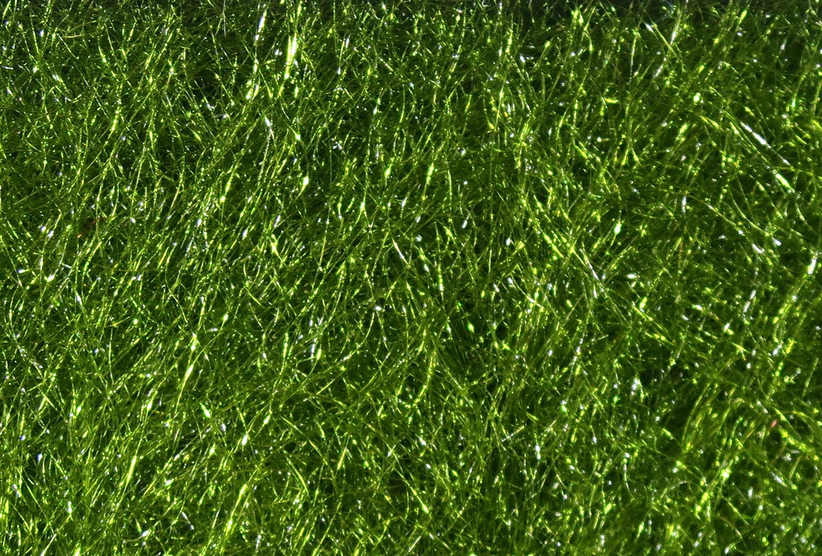 Bright olive green trilobal synthetic dubbing fibers with shiny fine iridescent strands for fly tying