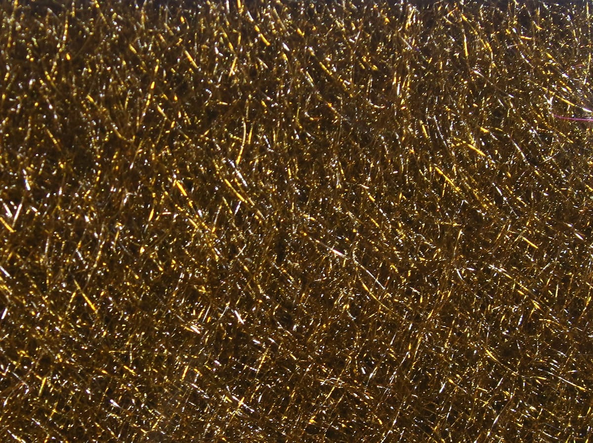 Gold metallic Hareline STS trilobal dubbing with dense shimmering synthetic fibers for fly tying
