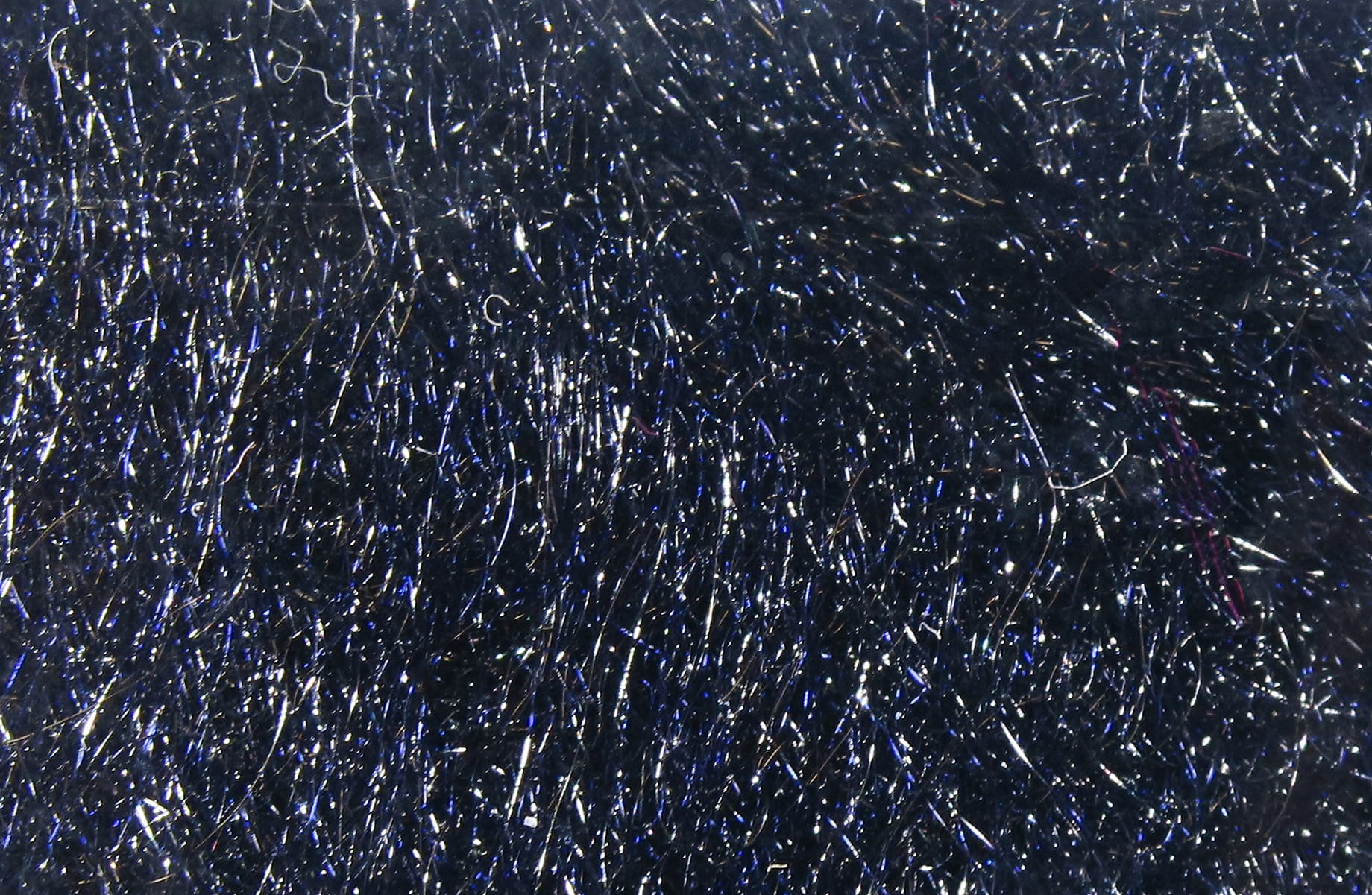 Dark navy trilobal synthetic dubbing with fine iridescent blue and silver sparkling fibers for fly tying
