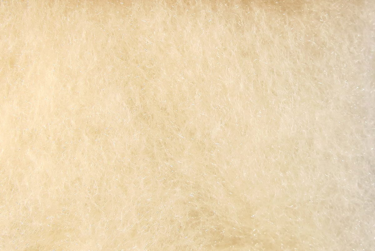Pale cream Hareline super fine dry fly dubbing, ultra-fine fluffy fibers with subtle iridescent sparkle for fly tying