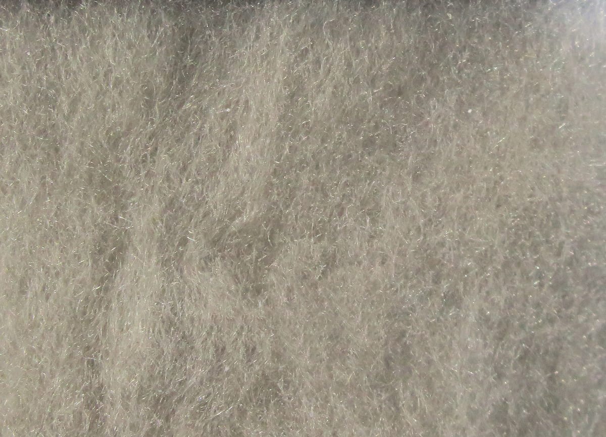 Soft pale gray Hareline fine dry fly dubbing with airy, fluffy fibers and subtle iridescent sparkle for fly tying