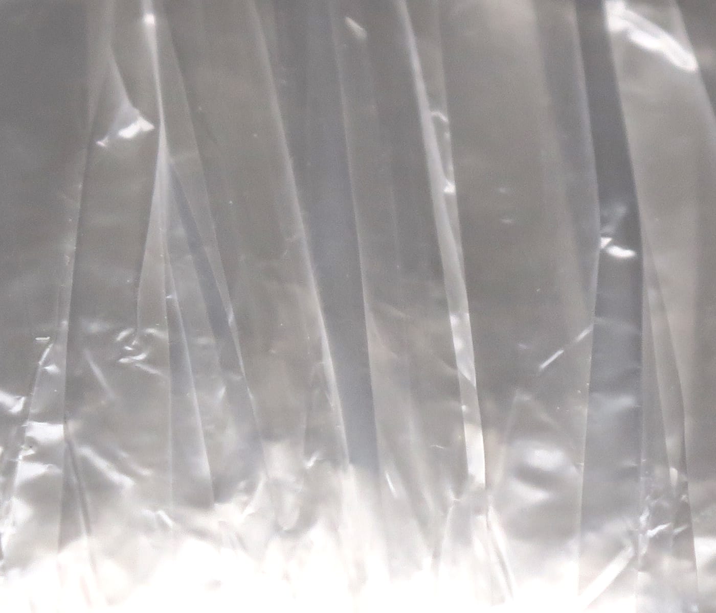 Hareline Swiss Straw translucent clear plastic strips for fly tying, thin glossy straw material with subtle vertical ribs
