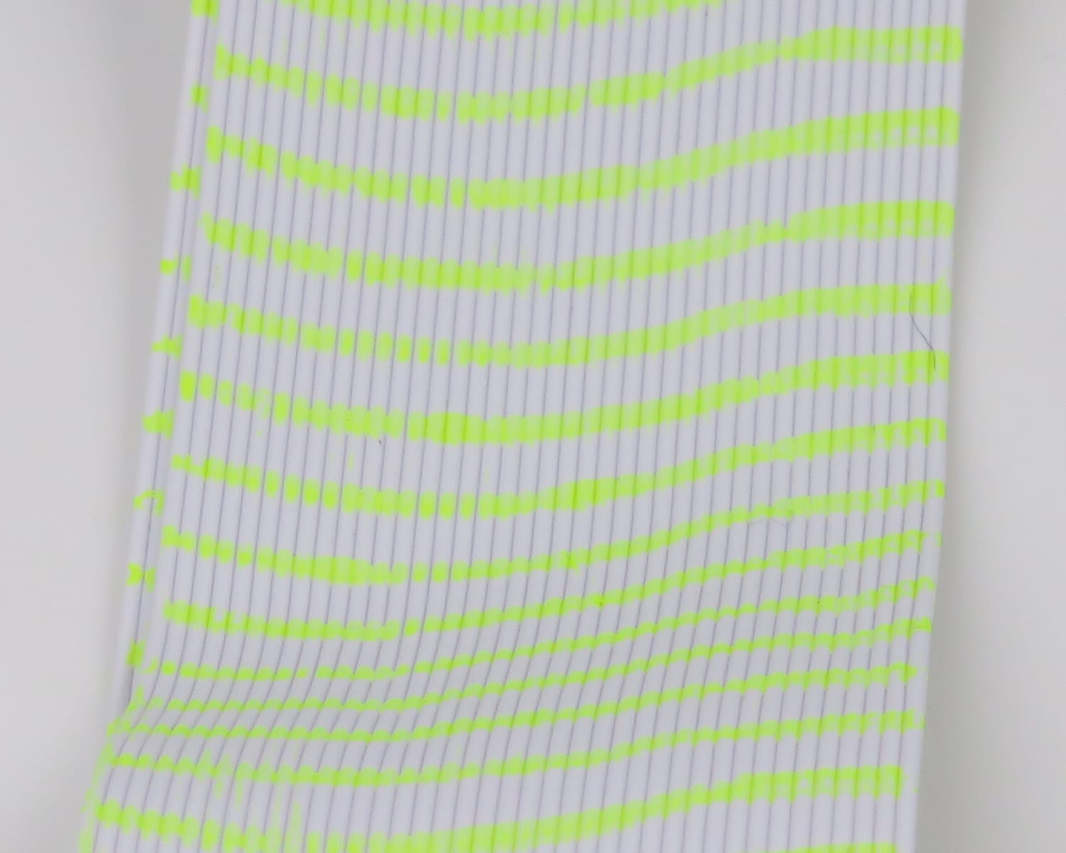 White ribbed synthetic tubing with bright chartreuse segmented stripes for fly tying legs, Hareline Tarantu-Leggs