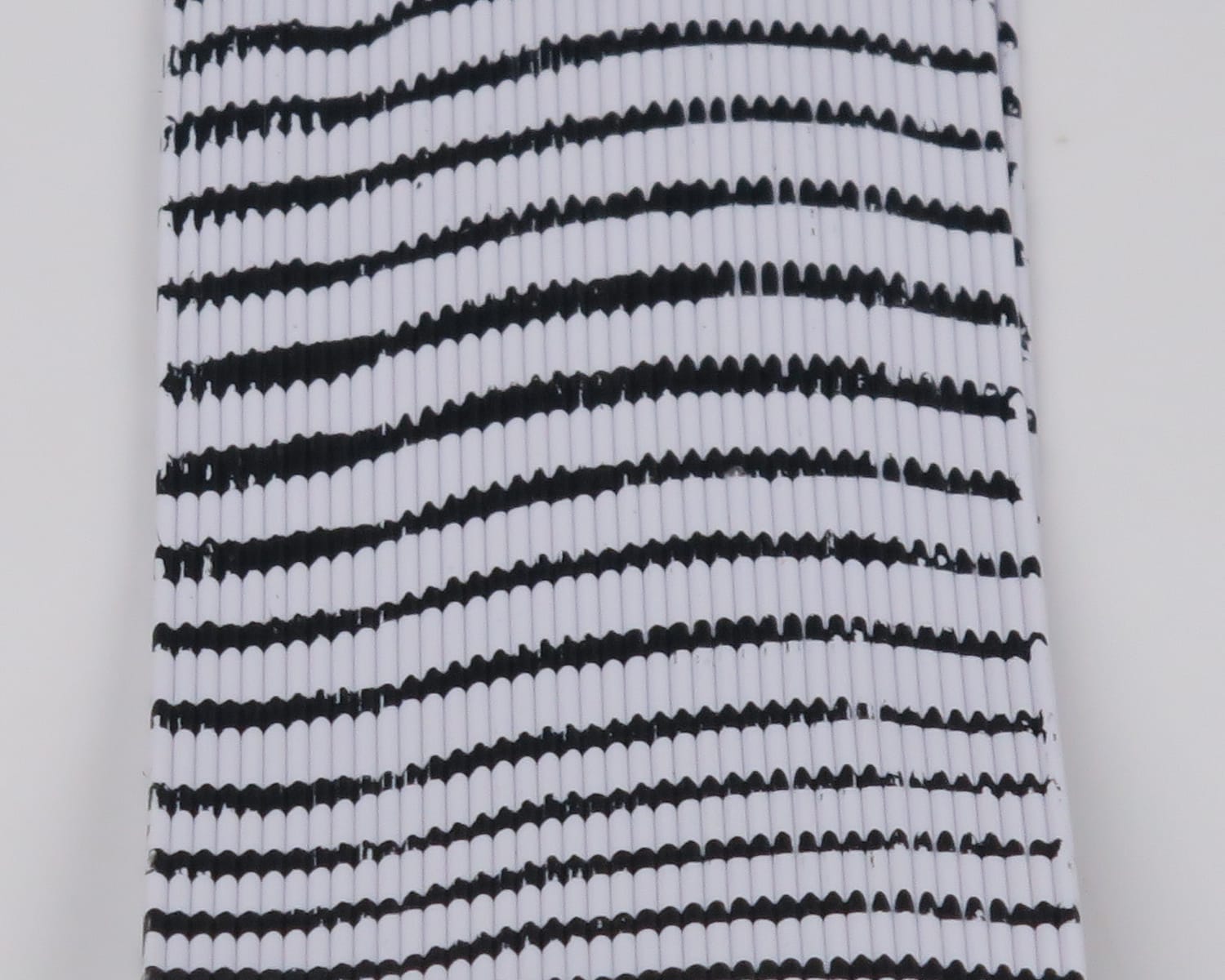 Hareline Tarantu-Leggs white segmented synthetic legs with irregular black stripes, ribbed material for fly tying