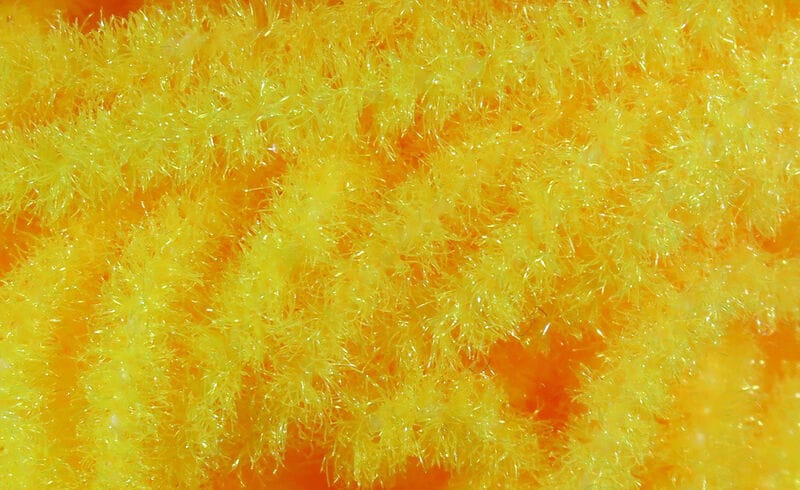 Bright yellow trilobal Antron chenille, sparkly fluffy synthetic fibers with iridescent halo for fly tying