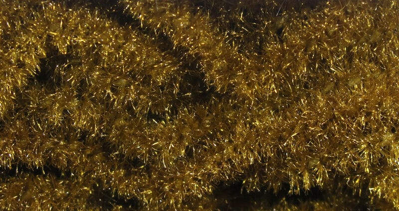 Hareline Trilobal Antron chenille close-up: dense golden metallic tinsel fibers with sparkling, fuzzy texture for fly tying