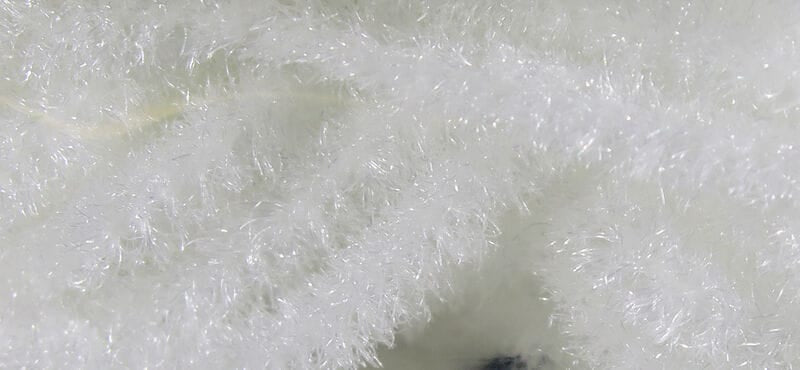 White Hareline Trilobal Antron chenille with sparkly, fuzzy synthetic fibers for fly tying, dense plush texture