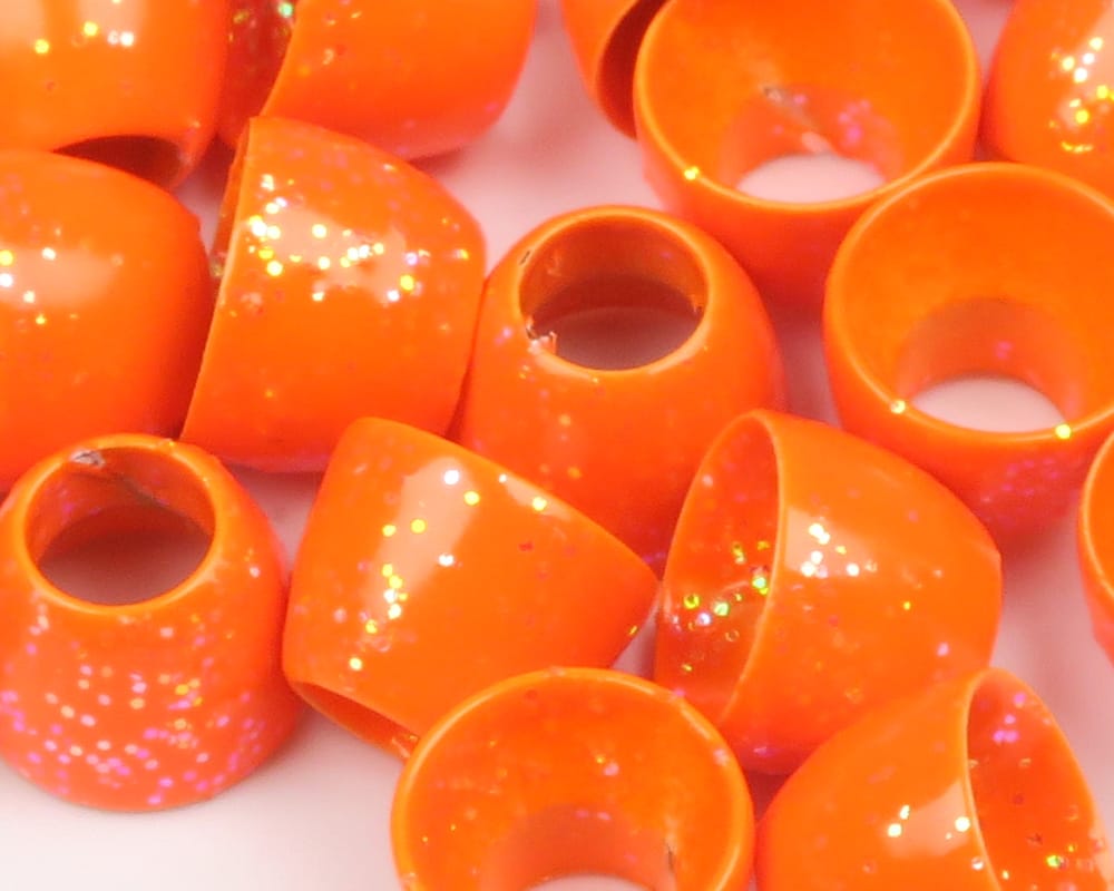 Bright orange Hareline tube cone heads with glossy finish and holographic glitter, hollow plastic cones for fly tying