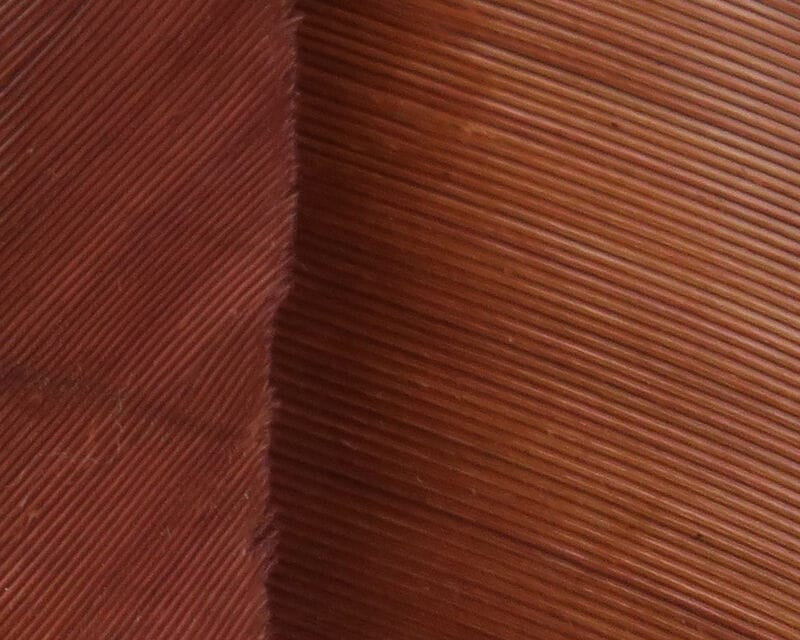 Hareline turkey biot quills close-up showing reddish-brown ribbed feather texture for fly tying