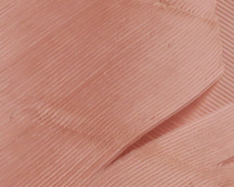 Salmon-pink turkey biot quills close-up showing fine ribbed texture, translucent feather strips for fly tying