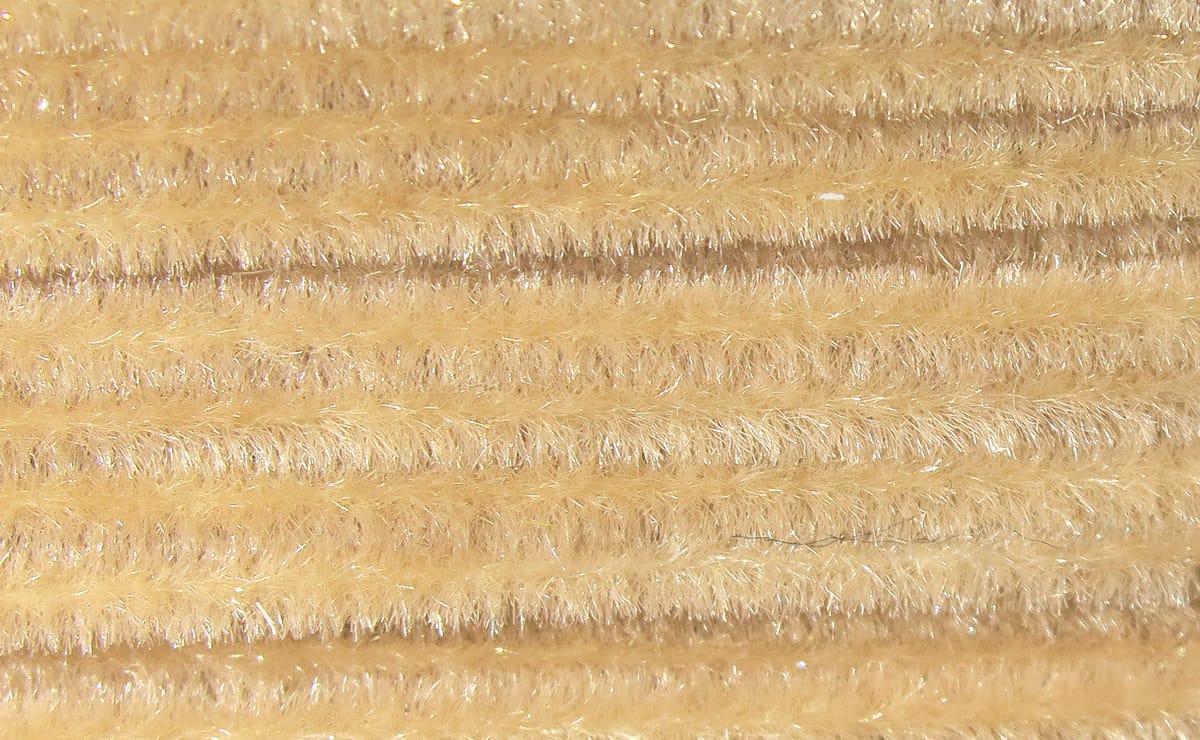 Beige Hareline Ultra Chenille fly tying material with fuzzy, sparkly fibers in parallel strands
