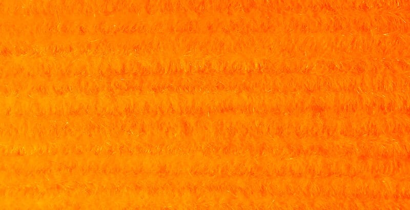 Bright fluorescent orange Hareline Ultra Chenille fuzzy yarn for fly tying with dense plush short fibers