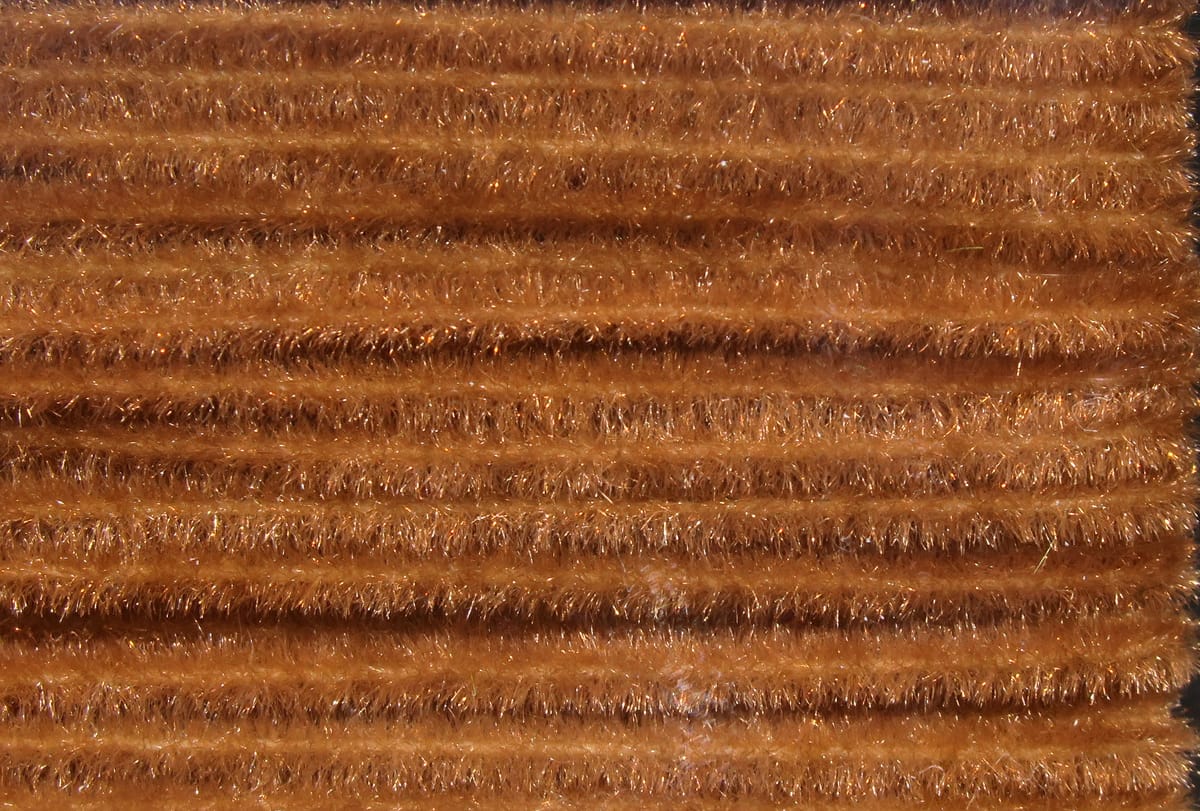 Hareline Ultra chenille in copper brown with sparkly tinsel fibers and dense fuzzy rows for fly tying