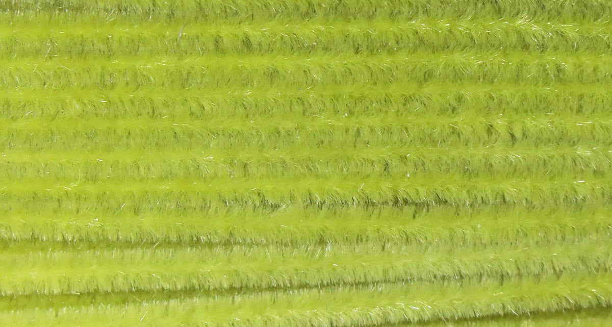 Bright chartreuse Ultra Chenille with fuzzy texture and fine silver tinsel fibers, soft yarn for fly tying