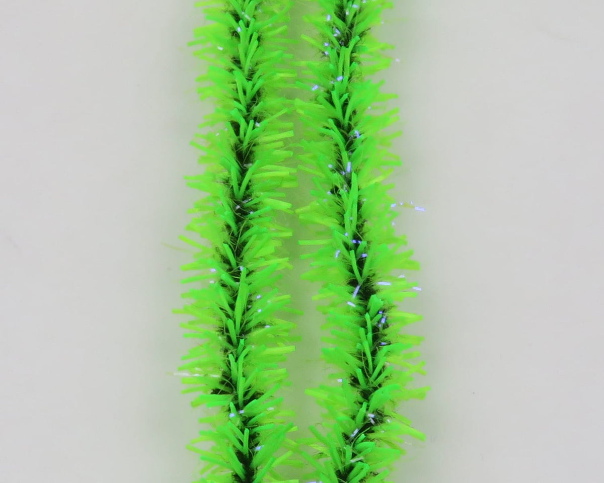Bright chartreuse Hareline UV Badger Flexi Squishenille chenille strands with black core and iridescent tinsel for fly tying