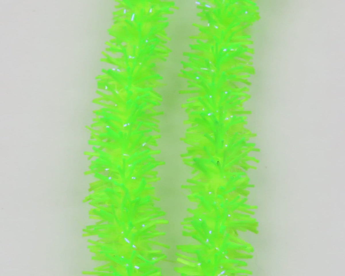 Neon chartreuse Hareline UV Flexi Squishenille strands with sparkly iridescent fibers for fly tying