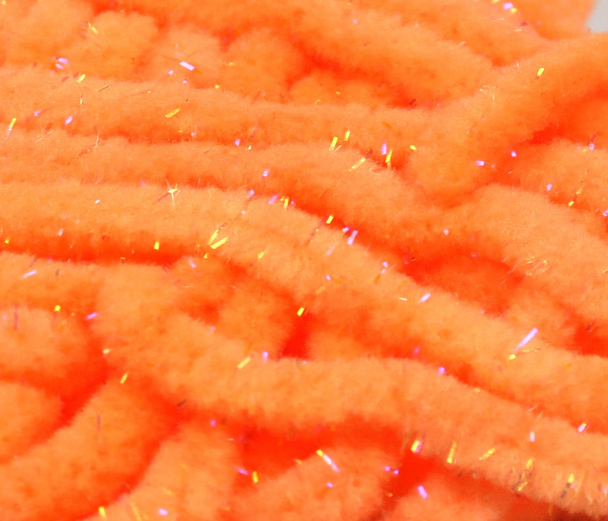 Bright orange Hareline UV Galaxy mop chenille strands with fluffy chenille texture and iridescent flash fibers for fly tying