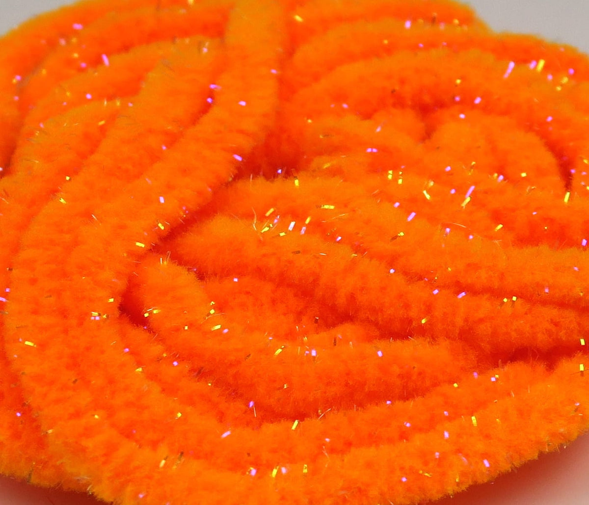 Bright fluorescent orange mop chenille with iridescent UV sparkle fibers, soft fluffy fly tying material coiled