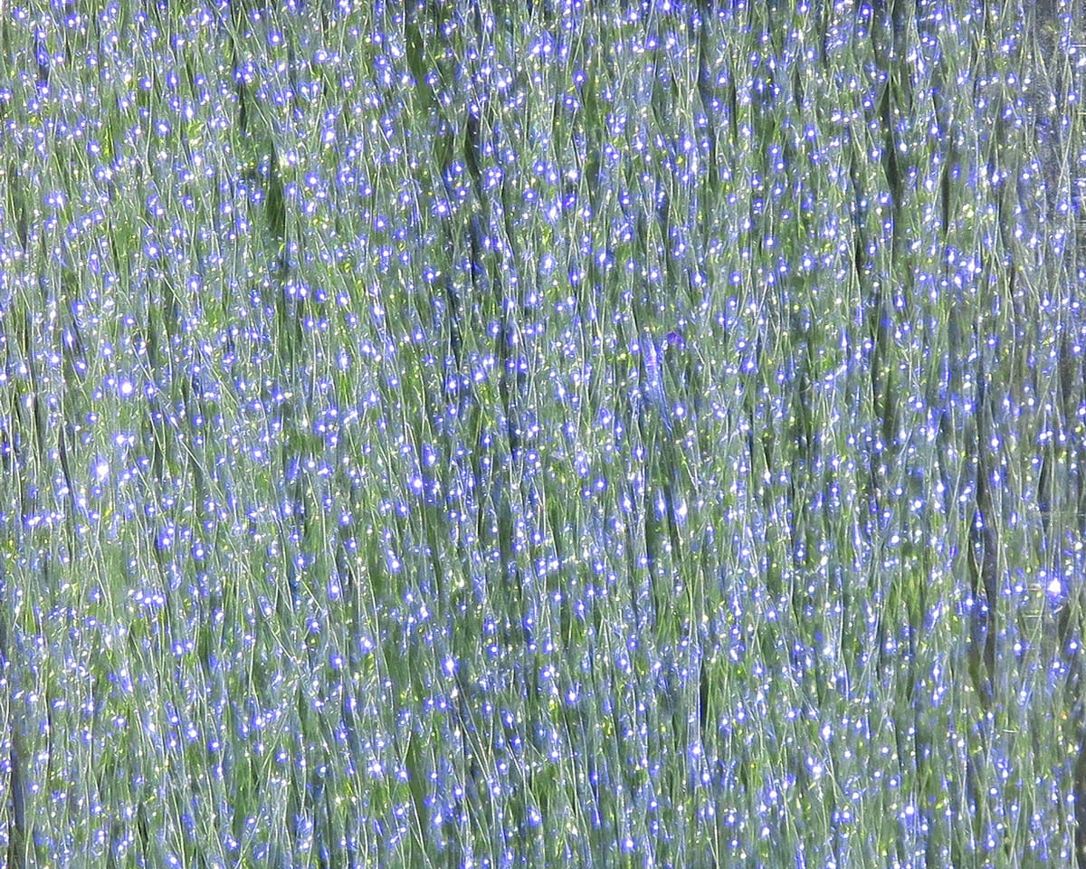 Krystal Flash shimmering pale green synthetic flash fibers with blue UV sparkles for fly tying