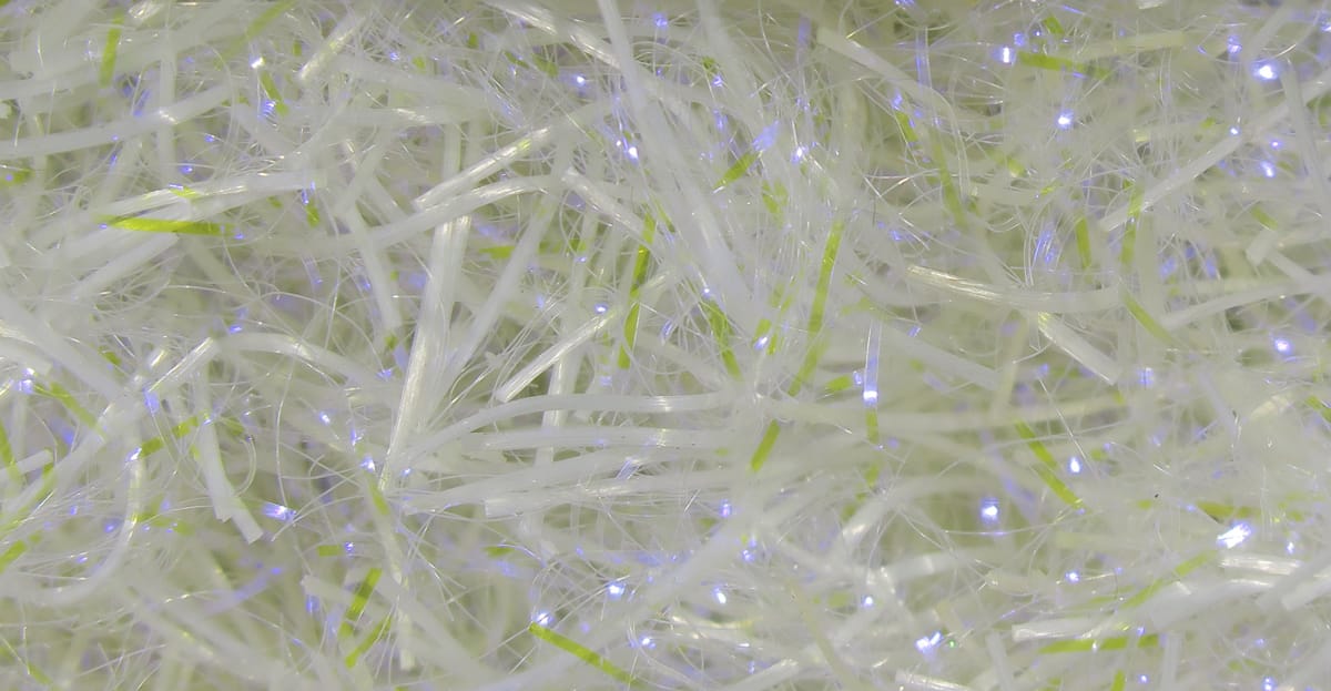 Hareline UV Life Flex Wrap pearlescent white synthetic strands with lime green rib and blue iridescent flash for fly tying