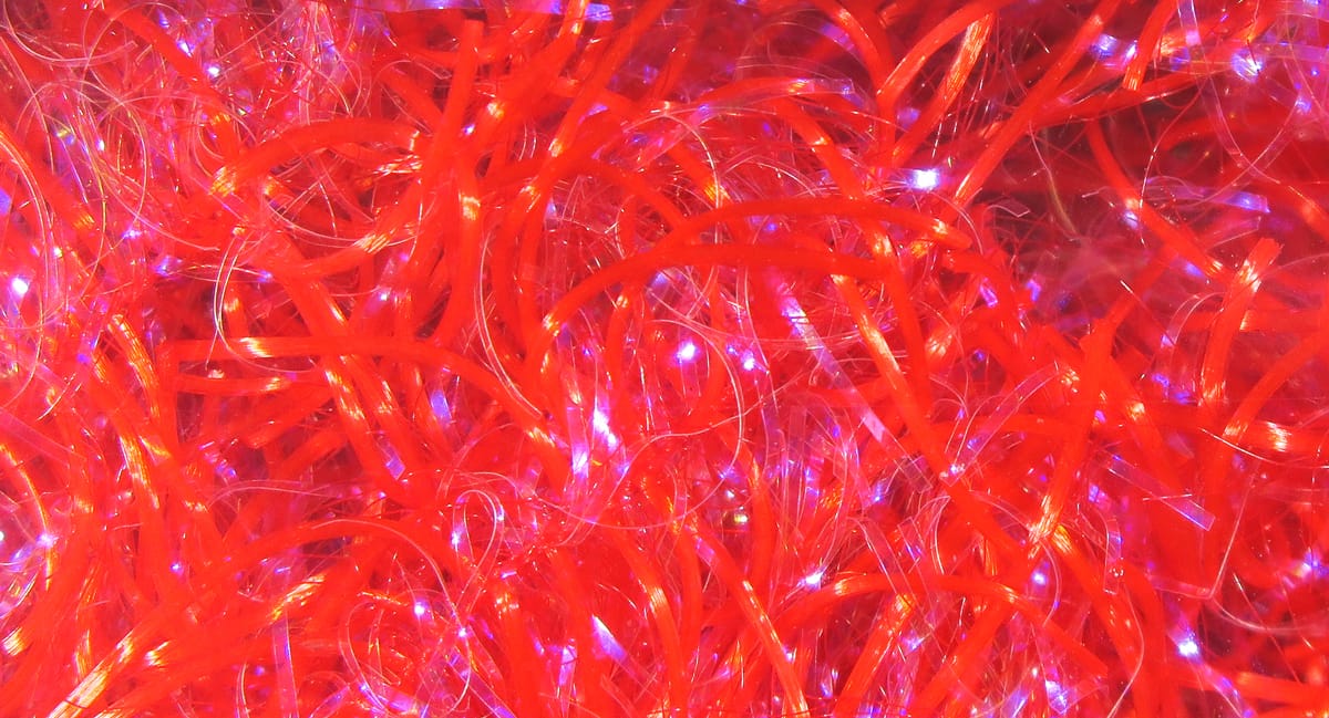 Hareline UV Life Flex Wrap bright red iridescent synthetic strands with translucent sparkling fibers for fly tying