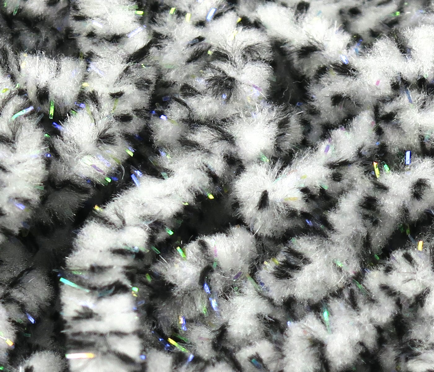 White and black mottled fluffy mop chenille with iridescent UV tinsel strands, textured fly tying material