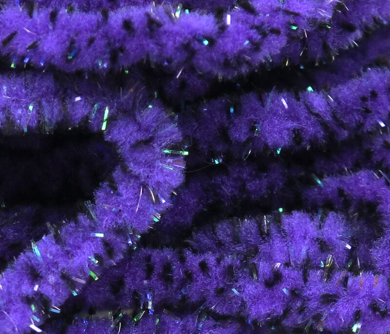 Purple mottled mop chenille with black speckles and iridescent tinsel fibers for fly tying