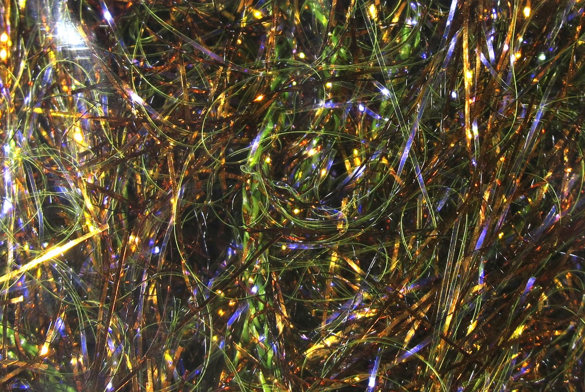 Iridescent UV polar chenille fibers in green, gold and purple holographic strands for fly tying