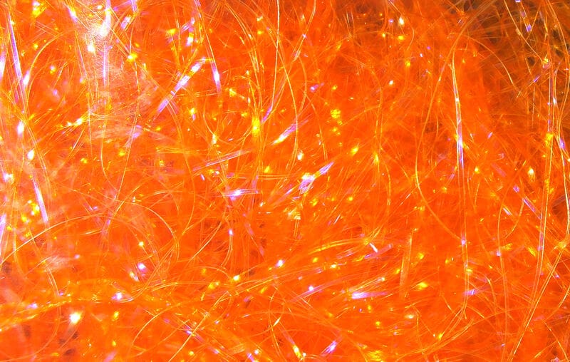 Hareline UV Polar Chenille bright orange iridescent synthetic fibers for fly tying, shimmering translucent strands