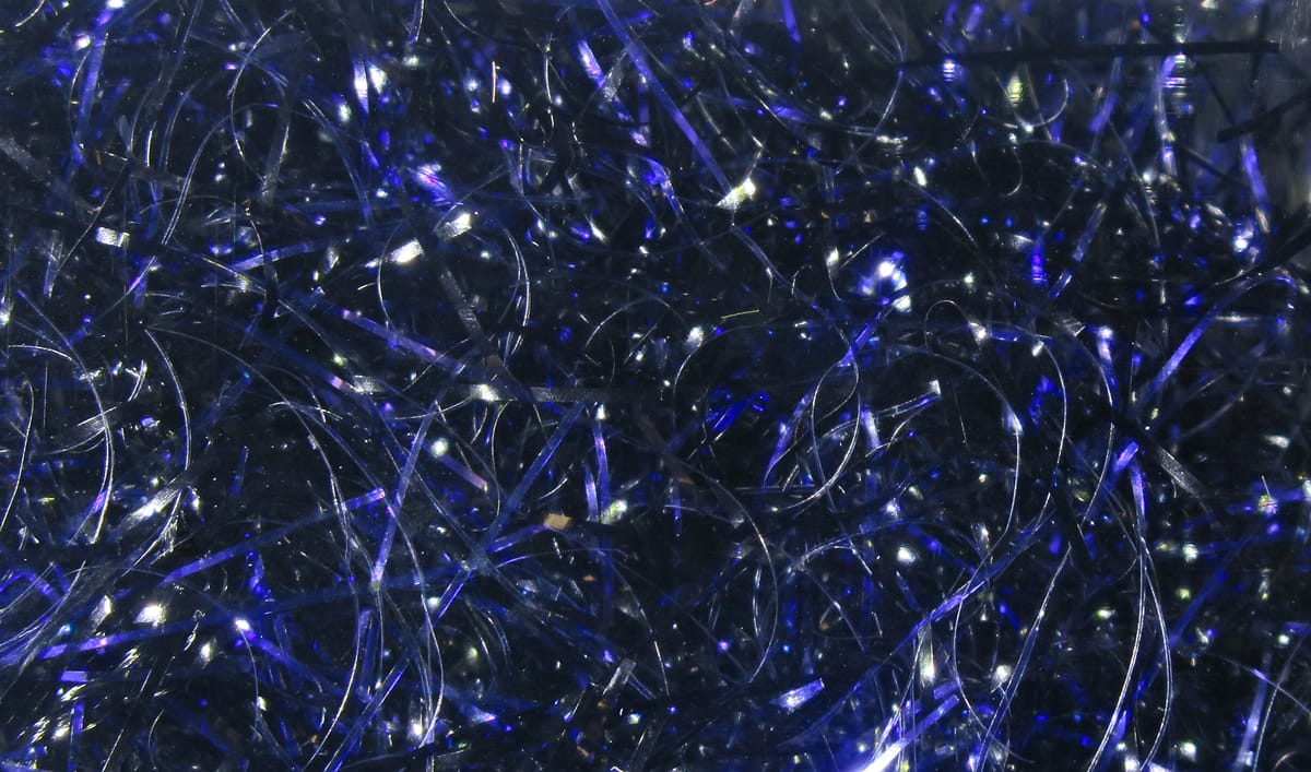 Dark blue iridescent polar chenille fibers with thin reflective strands for fly tying