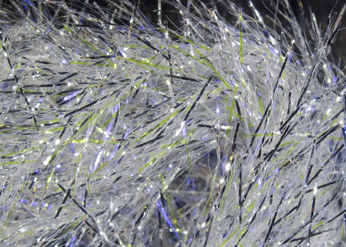 Hareline UV Polar Chenille white iridescent synthetic fibers with lime and black flash strands for fly tying