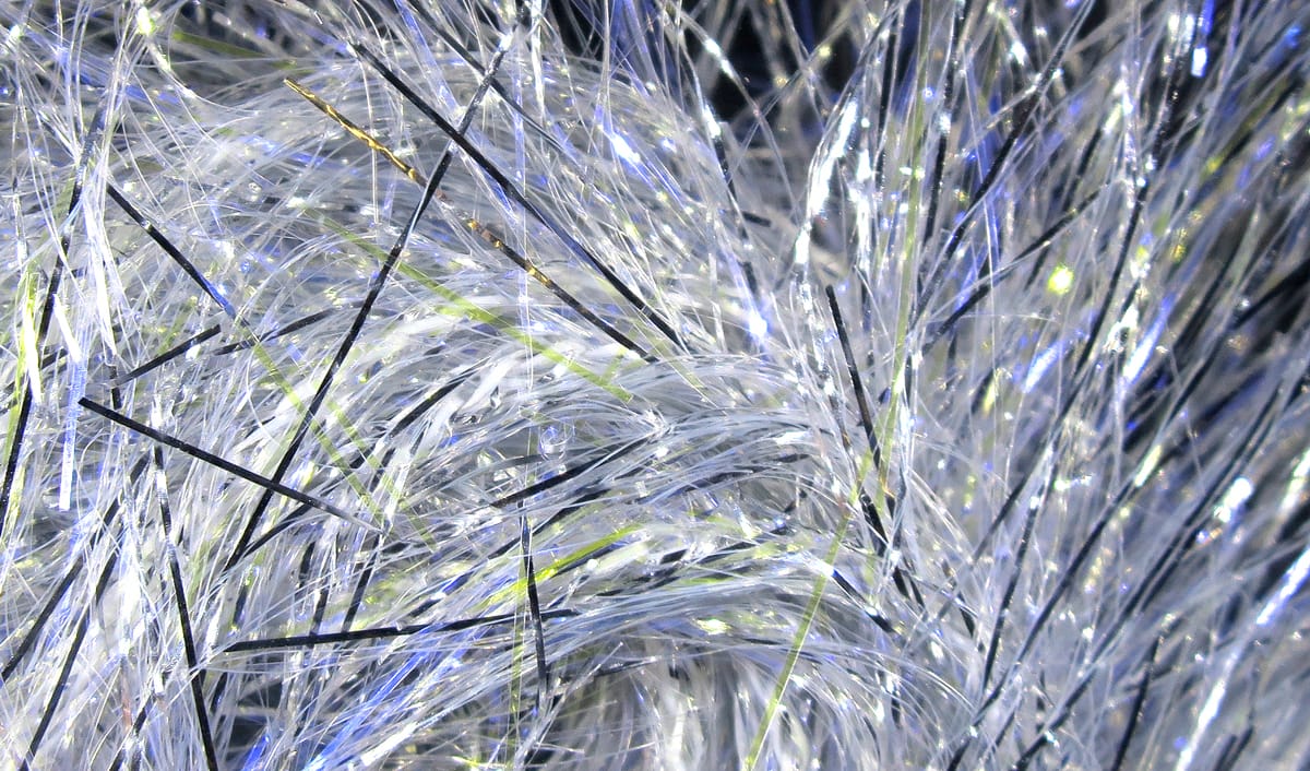 Hareline UV Polar Chenille shimmering translucent white synthetic chenille with black and lime flash fibers for fly tying