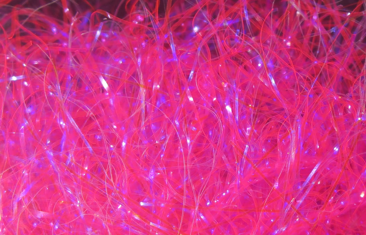 Hareline UV Polar Chenille in hot pink, fluffy iridescent synthetic fibers with shiny translucent strands for fly tying