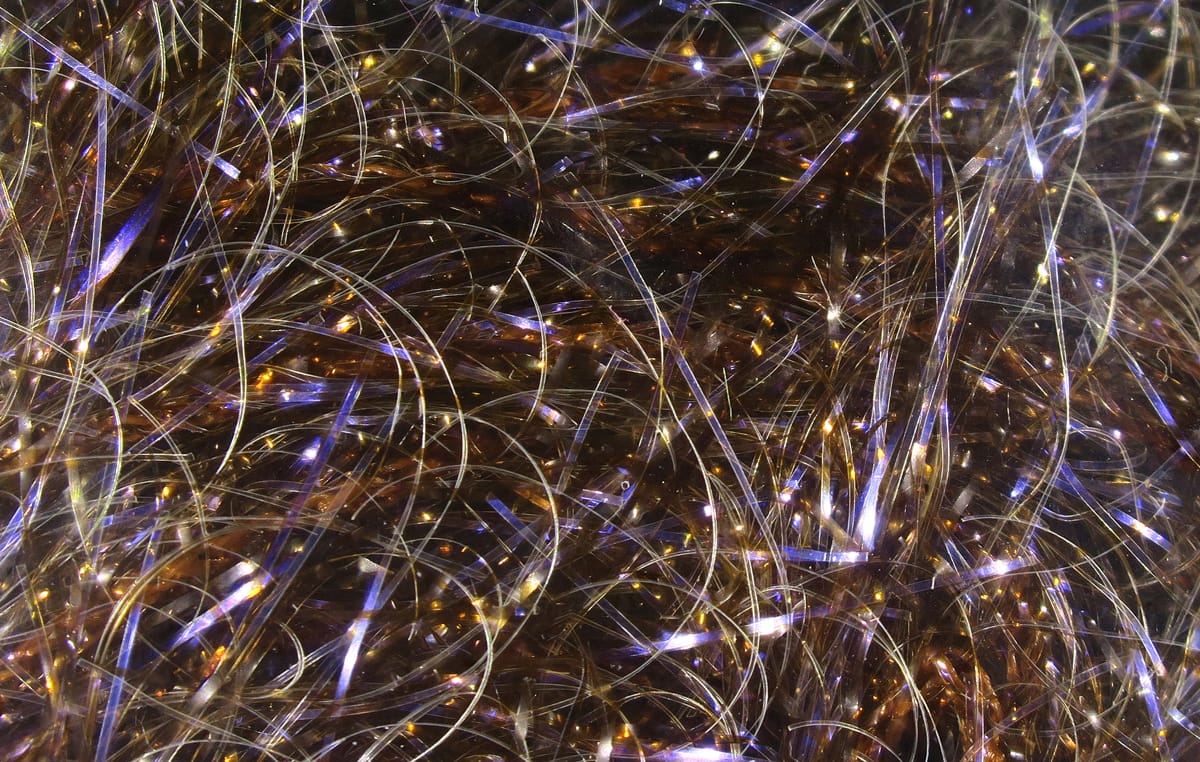 Hareline UV Polar Chenille brown synthetic fibers with purple-blue iridescent flash, shiny tinsel-like material for fly tying