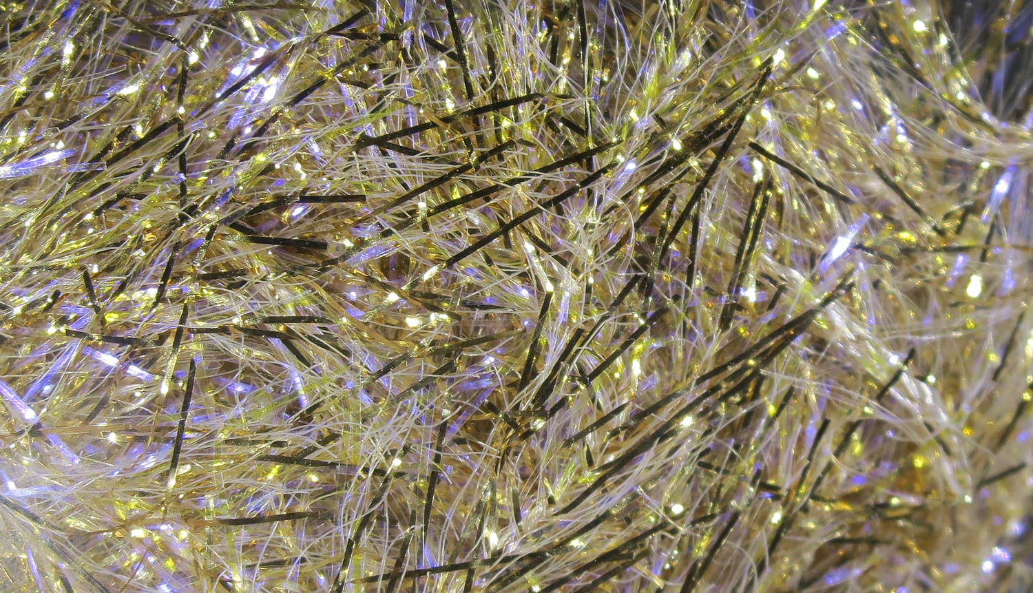 Hareline UV Polar Chenille, iridescent gold-olive synthetic chenille with fine white and black flash fibers for fly tying
