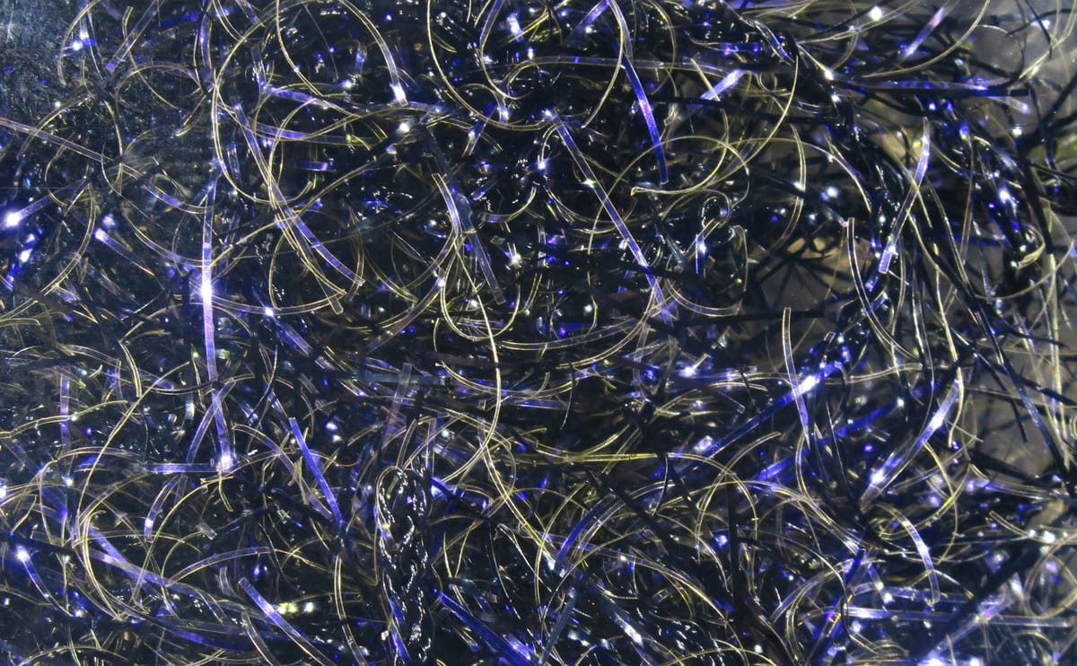 Shiny black and blue Hareline UV Polar chenille strands, iridescent thin fibers for fly tying