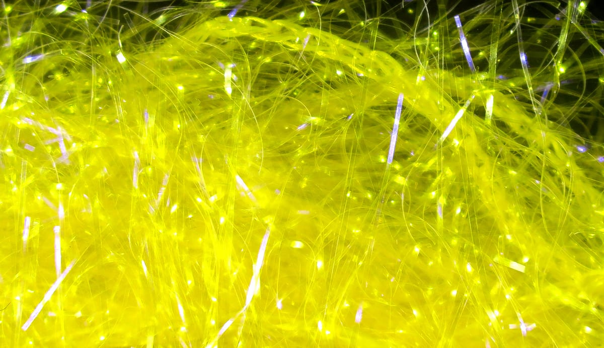 Hareline UV polar chenille fibers in bright chartreuse with iridescent tinsel flash for fly tying