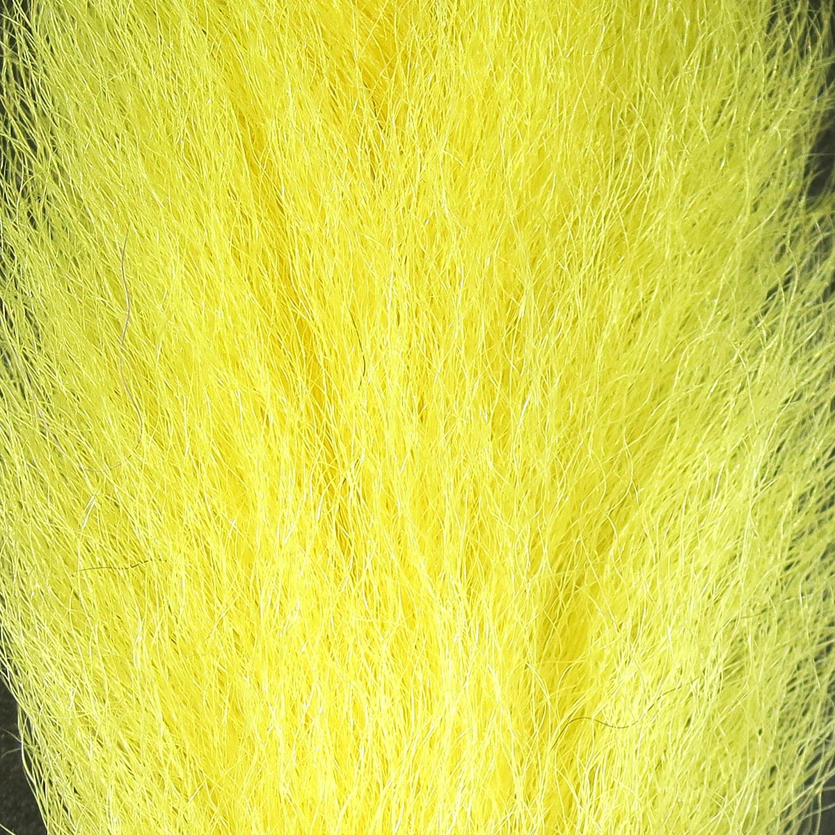 Bright chartreuse yellow Hareline UV2 calf tail fur with long fine fibers and subtle UV sheen for fly tying.