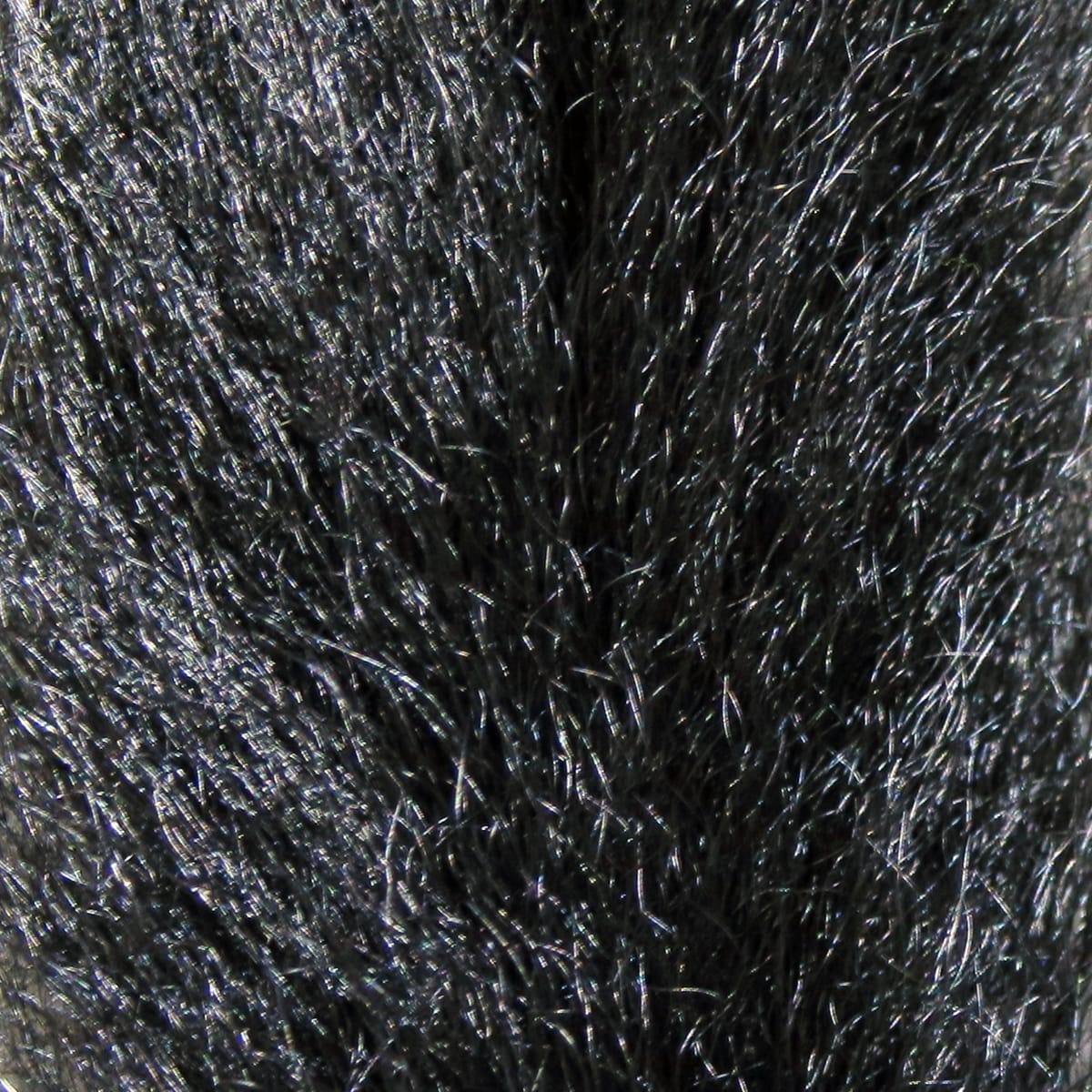 Glossy black calf tail hairs with fine, long fibers and subtle UV sheen for fly tying, dense natural fur texture