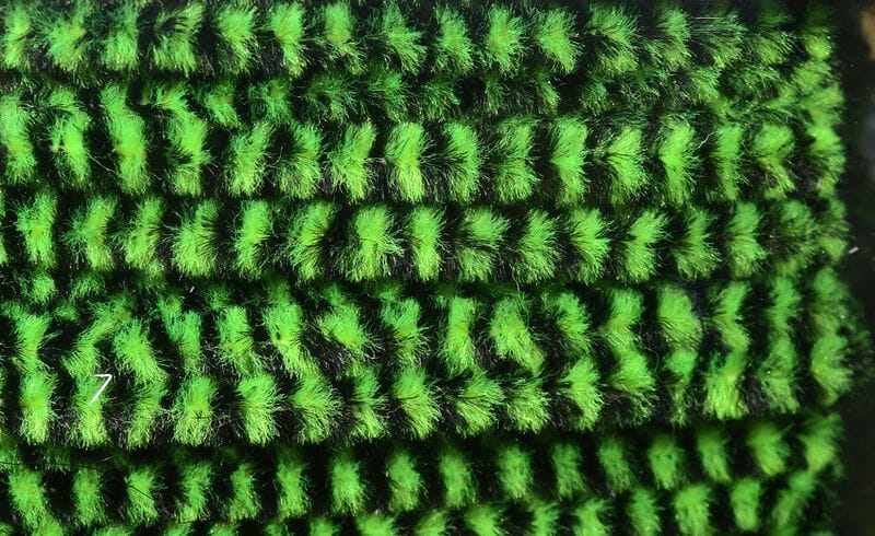 Hareline variegated chenille in neon green and black with fuzzy striped plush fibers for fly tying