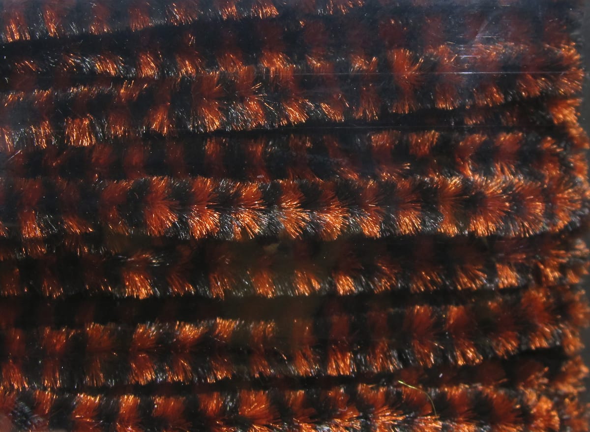Variegated chenille close-up, metallic burnt orange and black fuzzy striped material for fly tying