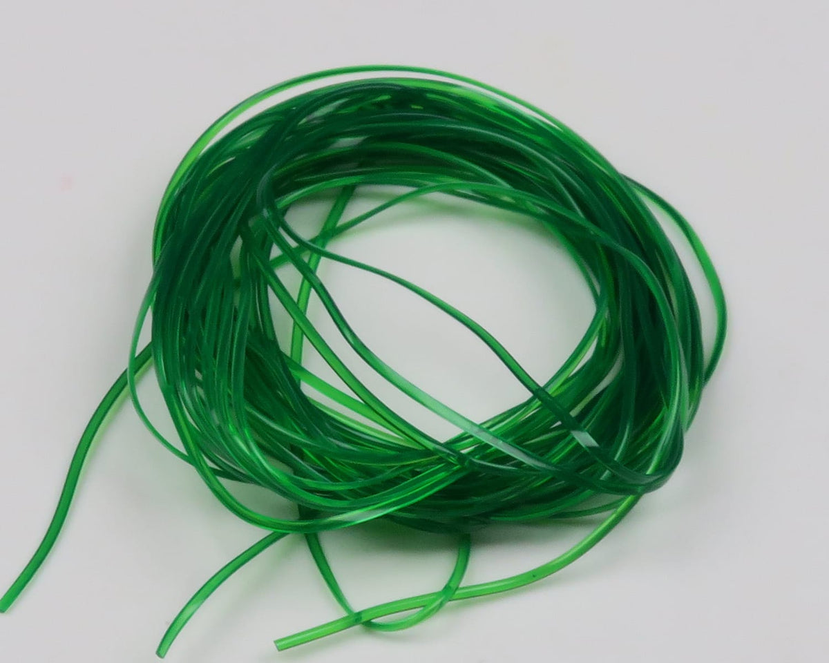 Hareline translucent green vinyl rib coil, thin glossy flat strands for fly tying on white background