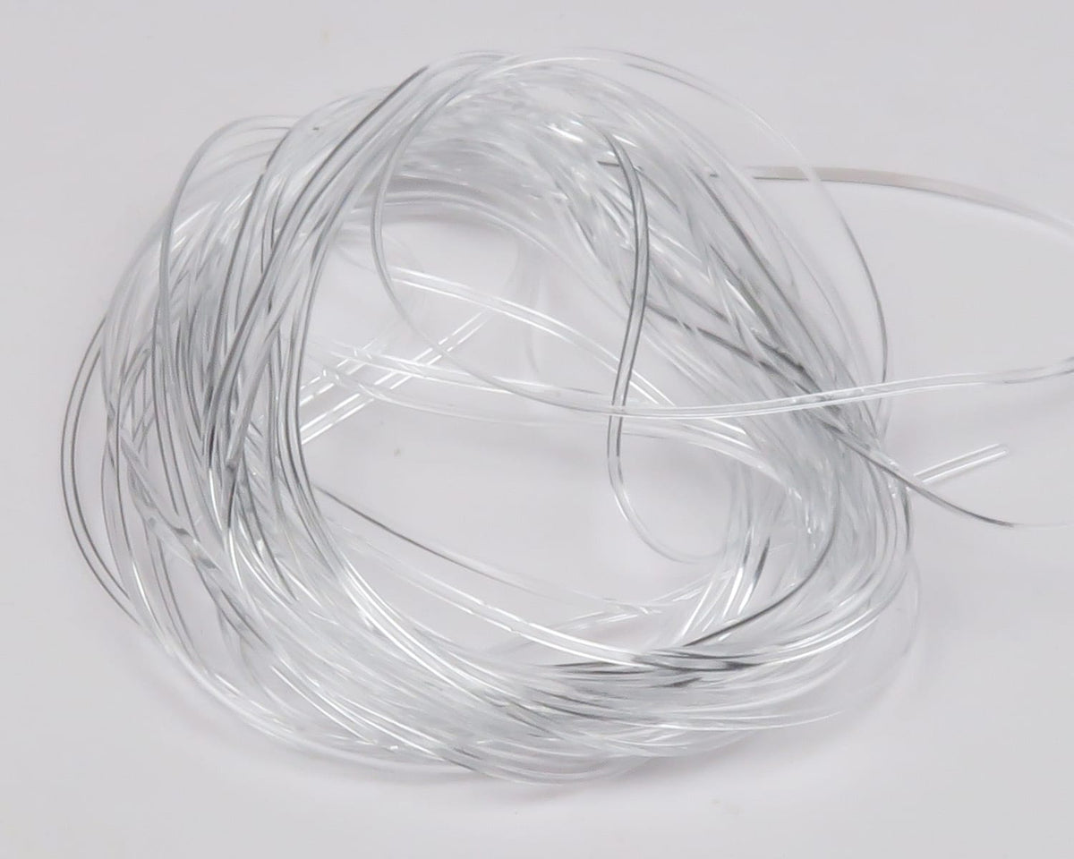 Coiled clear Hareline vinyl rib for fly tying, glossy transparent strands with thin silver ribbing
