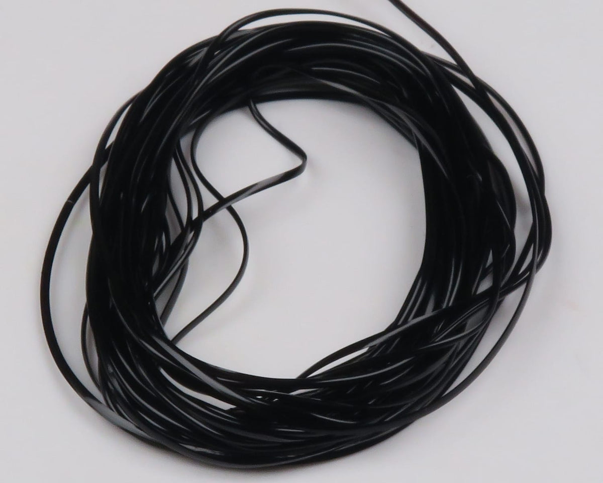 Black glossy vinyl rib coiled bundle, thin flat fly tying rib material on white background