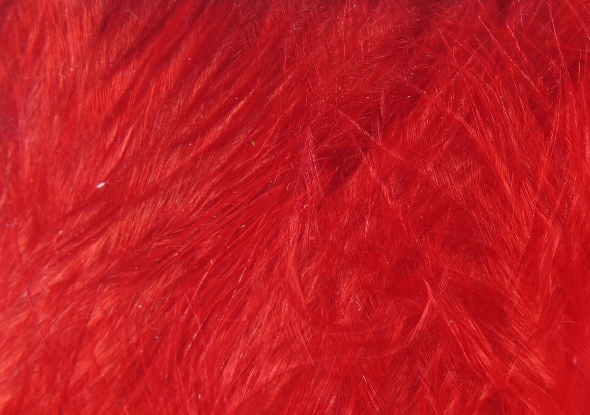 Bright red Hareline marabou feathers with soft, wispy fibers for woolly bugger fly tying