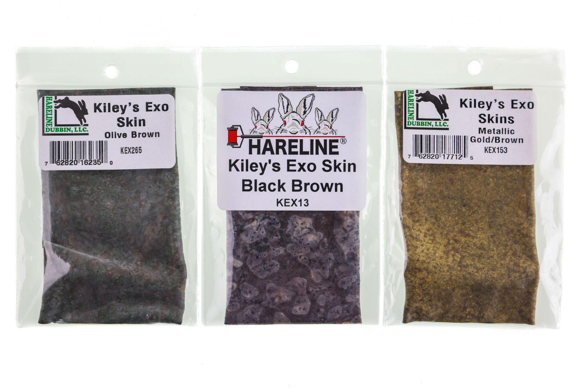 Kiley's Exo Skin fly tying sheets: left olive brown, center mottled black-brown, right metallic gold-brown in clear packaging