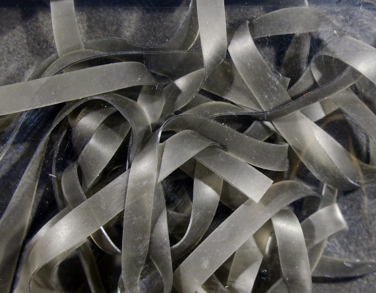 Translucent olive-gray rubber ribbon strips Kiley's Nymph Skins for fly tying, matte shimmery synthetic material