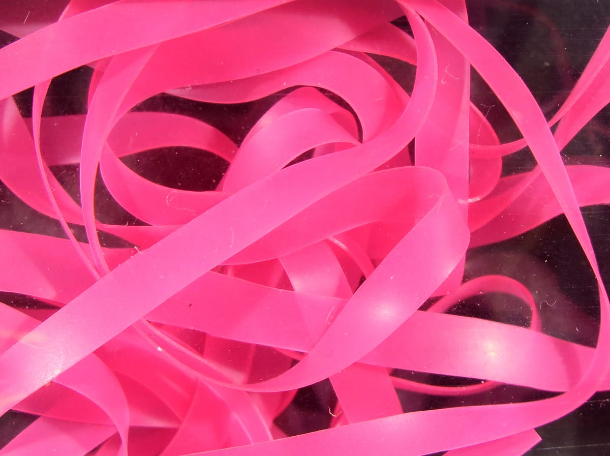 Bright hot pink nymph skins: translucent rubber ribbon strips for fly tying